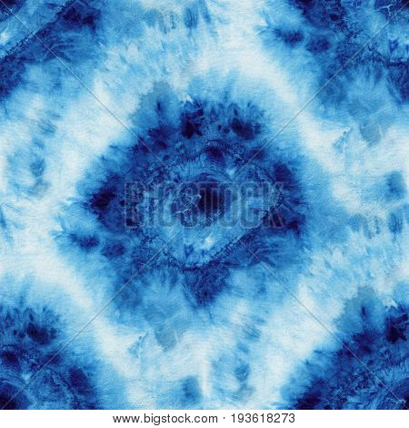 Seamless tie-dye pattern of indigo color on white silk. Hand painting fabrics - nodular batik. Shibori dyeing.