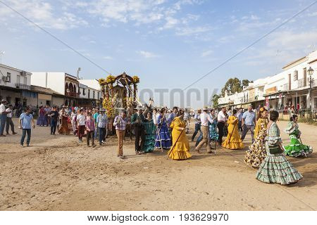 El Rocio Spain - June 2 2017: Procession of piilgrims in traditional spanish dress in El Rocio during the Romeria 2017. Andalusia Spain