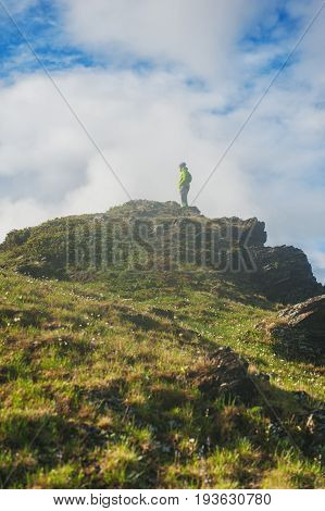 Hiker man standing on the top of mountain outdoor