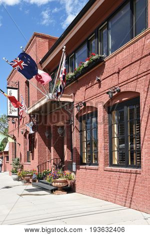 CODY, WYOMING - JUNE 24, 2017: The Chamberlin Inn. the historic hotel and landmark, has 21 units made up of a series of suites, rooms, cottage and garden studios.