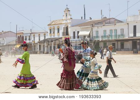 El Rocio Spain - June 2 2017: Female pilgrims in traditional flamenco dresses in El Rocio during the pilgrimage Romeria 2017. Province of Huelva Andalusia Spain