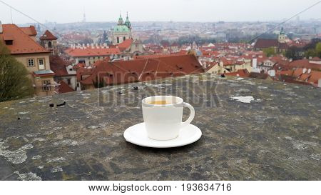 coffee mug on the floor with view of prage.
