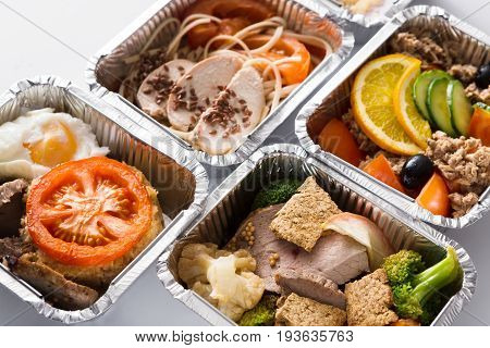 Healthy restaurant meals take away and delivery. Diet concept. Everyday dietary menu, meat with garnish and vegetable salad in take away boxes, background