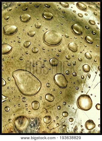 drops of rain on a metal golden