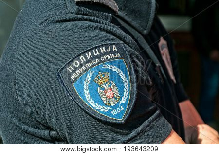 Shirtsleeve with emblem of Serbian police. Translation - Police, Republic of Serbia. March -26. 2017. Novi Sad, Serbia.