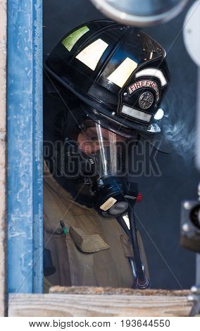 Firefighter Training Man Standing In A Smoky Window
