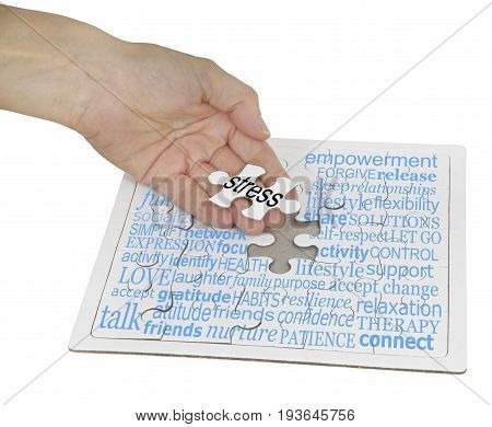 Stress Management Puzzle Word Cloud -  a hand holding the final jigsaw piece over a jigsaw puzzle  showing a word cloud containing words relevant to stress management