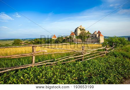 Rupea Romania - June 23 2013: Tourists visiting the old medieval fortress on top of the hill Rupea village located in Transylvania Romania