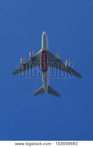 Almere, The Netherlands - July 3, 2017: Emirates Airbus A380-800 (A6-EDR) flies above the city of Almere.
