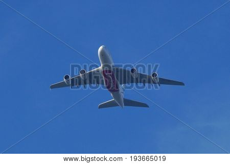 Almere, The Netherlands - July 3, 2017: Emirates Airbus A380-800 (A6-EDR) flies above the city of Almere.