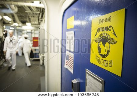 Ship Tour USS Kearsarge (LHD 3) Wasp-class amphibious assault ship: Avionic Work Center sign in corridor. Fleet Week NEW YORK MAY 25 2017.