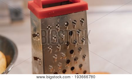 A Grater For Rubbing Vegetables And Potatoes Close-up. Preparation Of Ukrainian Deruns. Recipe For T