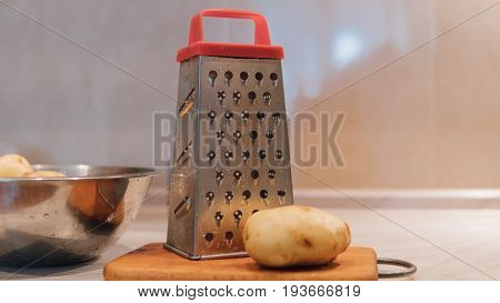 A Grater For Rubbing Vegetables And Potatoes Close-up. Preparation Of Ukrainian Deruns. Recipe For T