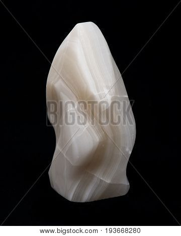 Polished cream white carved onyx on black background