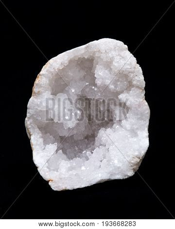 Clear crystal quartz geode with crystalline druzy center on black background