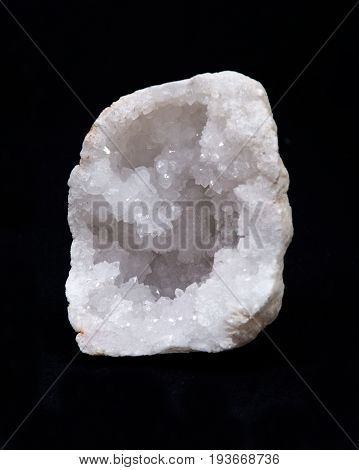 Clear crystal quartz geode with crystalline druzy center on black background