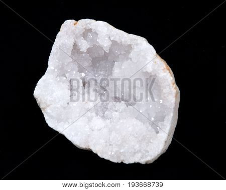 Clear crystal quartz geode with crystalline druzy center on black background