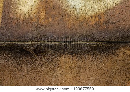 Two parts of Rusted metal plates texture with peeling metal along the joint close up