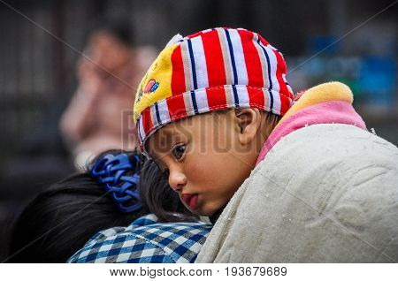 MUANG SING, LAOS - DECEMBER 28, 2012: Little kid in the morning market in the village of Muang Sing Laos