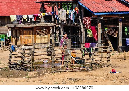 MUANG SING, LAOS - DECEMBER 28, 2012: Local family washing in a small ethnic community near the village of Muang Sing in Laos
