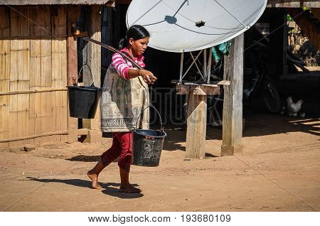 MUANG SING, LAOS - DECEMBER 28, 2012: Local girl in a small ethnic community near the village of Muang Sing in Laos