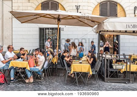 Rome Italy - August 18 2016: Sidewalk restaurant with tourists in Mignanelli Square in Rome a sunny summer day