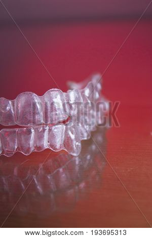 Plastic dental orthodontics on colored background. No people