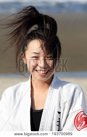Kagawa, Japan - January 3, 2017: Japanese martial arts houses, young girl training of karate at the new year at the Ichinomiya beach.