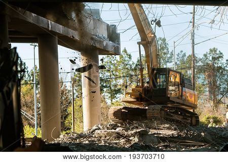 ATLANTA, GA - APRIL 2017:  A crane knocks down a section of I-85 South just imploded following the collapse of the I-85 North bridge from a fire in Atlanta GA on April 1 2017.
