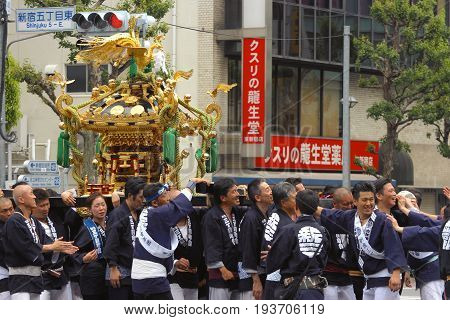 2017 05 28. SHINJUKU TOKYO JAPAN. People are carrying a portable shrine on their shoulders and walking around shinjuku city. known as OMIKOSHI MASTURI FESTIVAL at HANAZONO JINJA, SHINJUKU TOKYO JAPAN