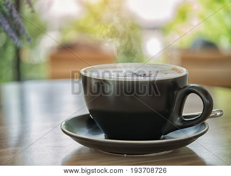 Hot cappucinno coffee on the table at coffee shop