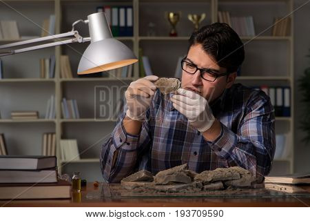 Archeologist working late night in office