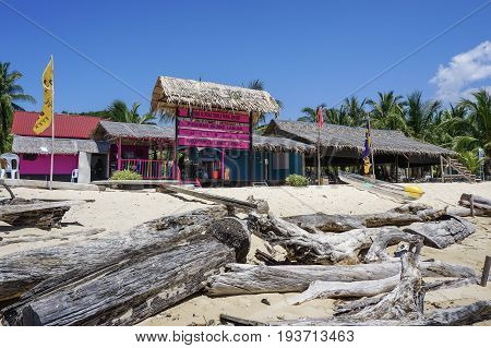 Labuan,Malaysia-May 1,2017:Colourful resort chalets with beautiful sandy beach at Rusukan Besar island in Labuan,Malaysia.It is a popular place for tourist to visit & snorkeling underwater in Labuan