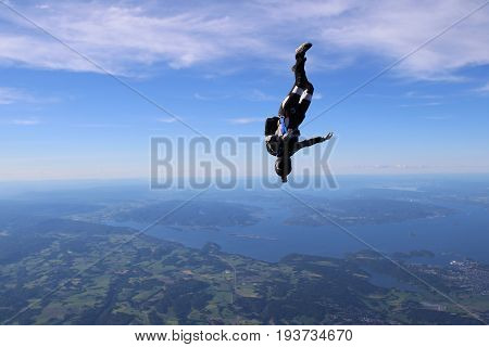Skydiving over beautiful Norway. Clouds, sun and sky