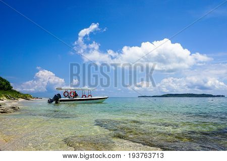 Labuan,Malaysia-May 1,2017:Tropical beach background and wonderful nature landscape with sandy beach & tourist boat in Rusukan Besar island,Labuan,Malaysia.