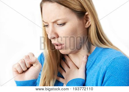 Studio Shot Of Young Woman Suffering With Cough