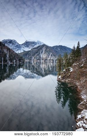 Mountain lake against the backdrop of snow-capped mountains. Rizza Abkhazia