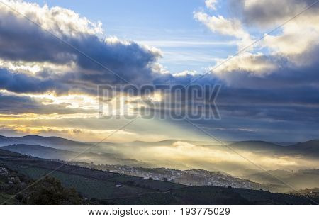 Stunning overview of Guadalupe village during a foggy sunrise Caceres Spain