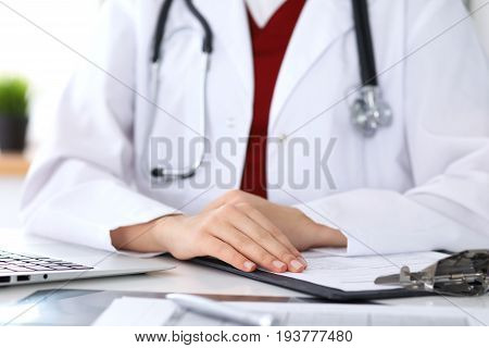 Close up of a unknown female doctor's hands. Physician is ready to consult and halp patients. Medicine and health care concept