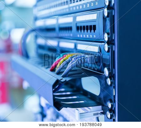Network cables in switch and firewall in cloud computing data center server rack