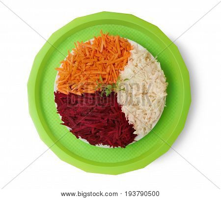 Various grated fresh vegetables on green tray