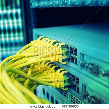 Network cables in switch and firewall in cloud computing data center server rack