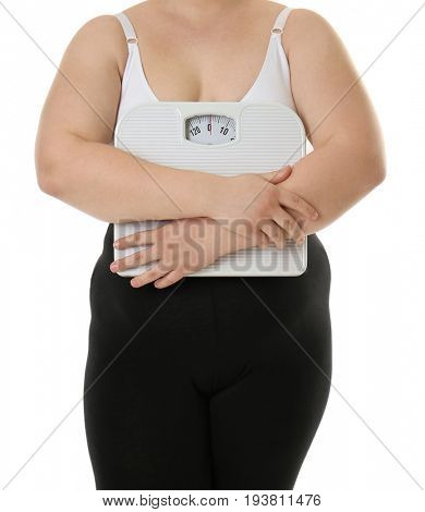 Overweight woman holding scales on white background. Diet concept