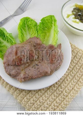 Bio neck steak with salad and caper sauce