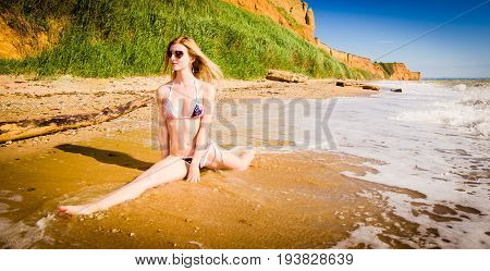 Young hot slim blonde on the beach