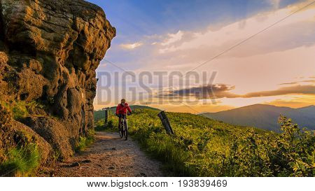Mountain biking women riding on bike in summer mountains forest landscape. Woman cycling MTB flow trail track. Outdoor sport activity.