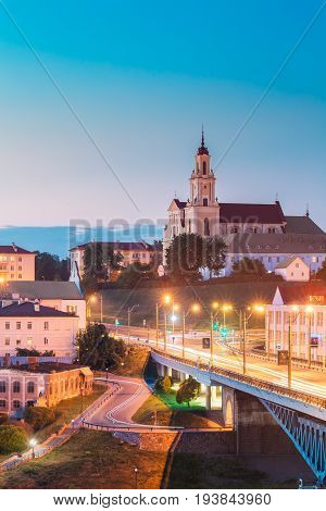 Grodno, Belarus - June 9, 2017: Catholic Church Of The Discovery Of The Holy Cross And Bernardine Monastery At Evening In Night Illuminations Lights. Blue Hour In Hrodna. Sunset Sky