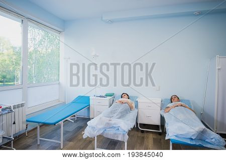 Female patient sleeping in medical bed at the hospital ward.