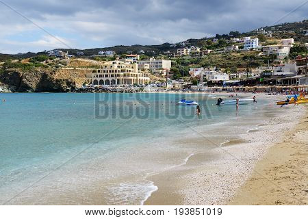 CRETE GREECE - MAY 16: The tourists enjoiying their vacation on the beach on May 16 2014 in Crete Greece. Up to 16 mln tourists is expected to visit Greece in year 2014.