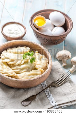 Served boiled traditional vareniks and sour cream
